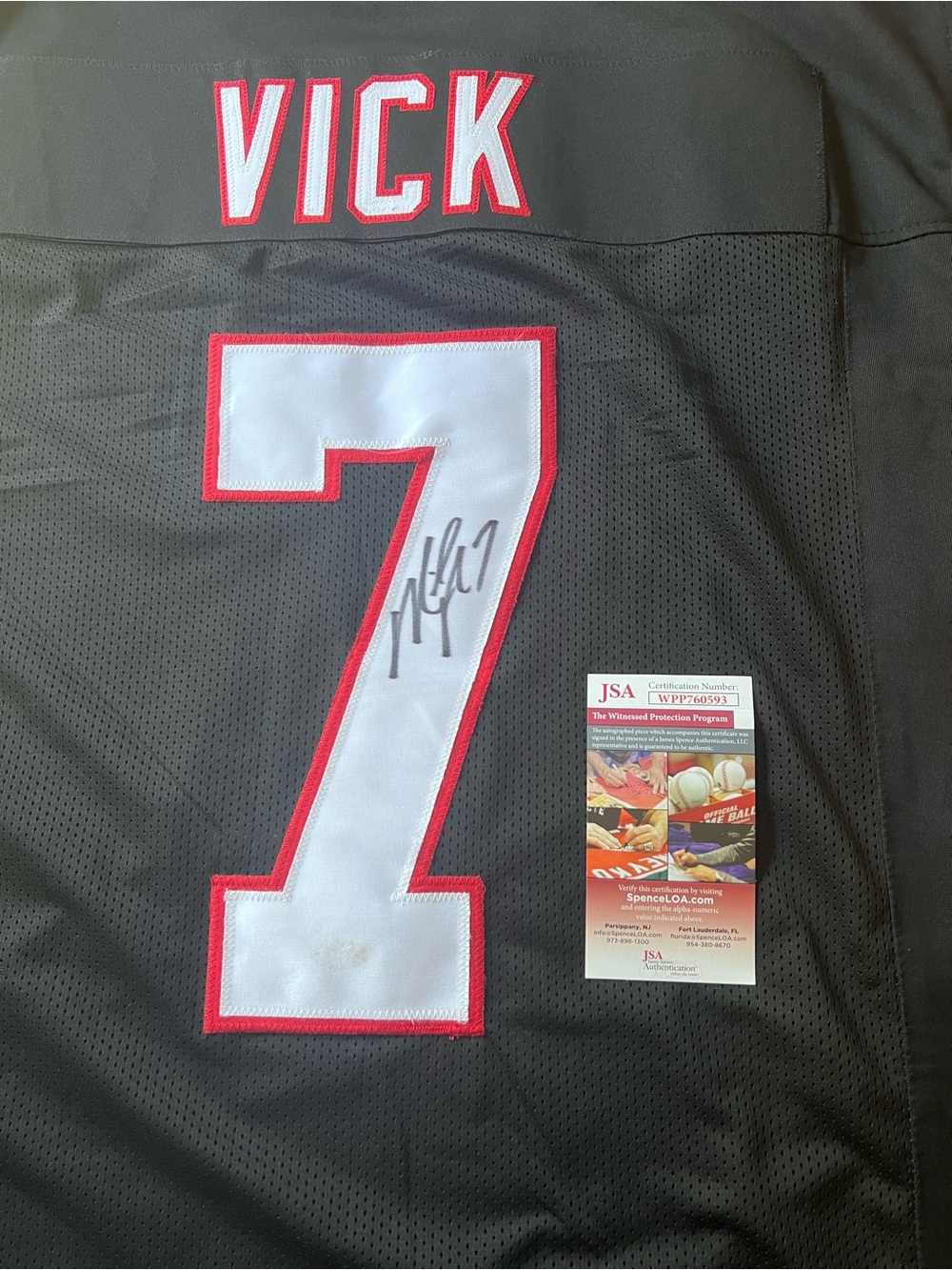 Autographed Vick #7 Football Jersey in Black and White with Red Trim